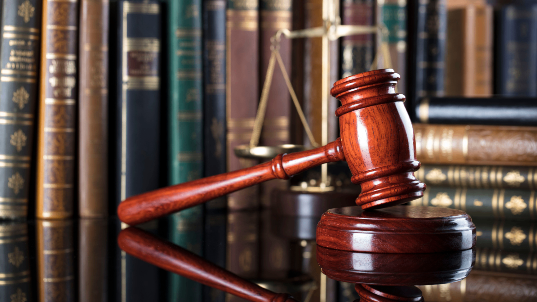 Gavel resting on legal books in a law library
