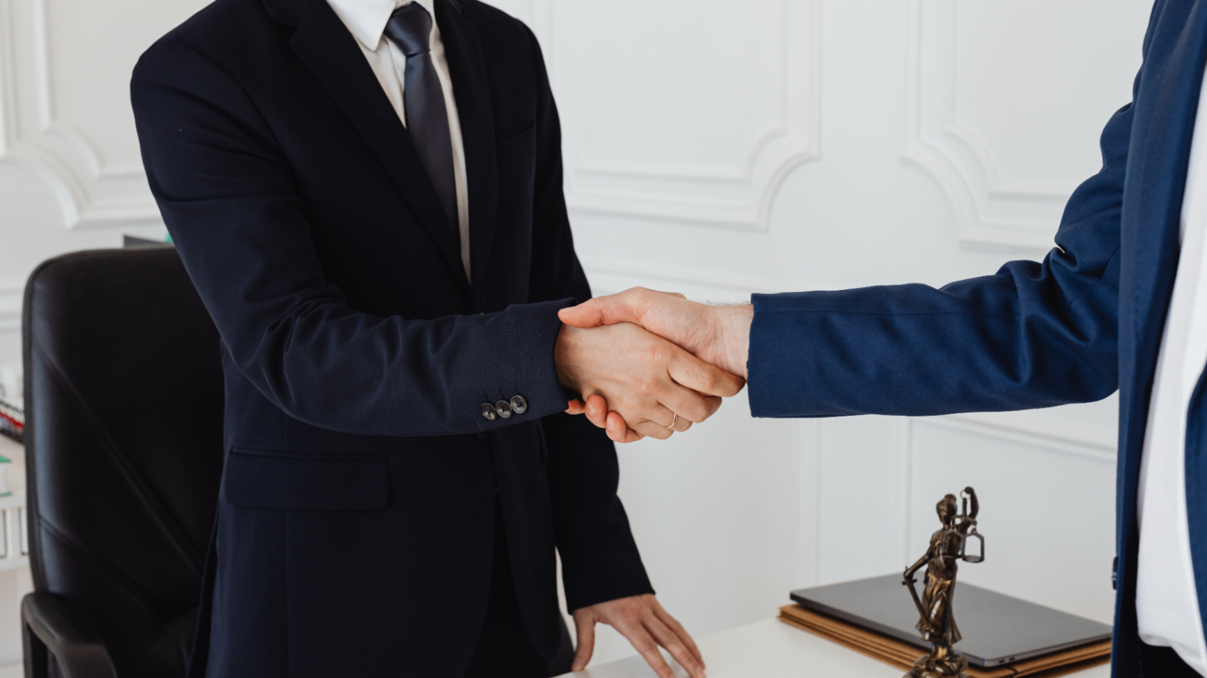 Buyers and lawyer shaking hands after a property closing